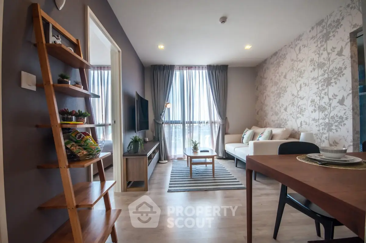 Modern living room with stylish decor and large windows offering natural light.