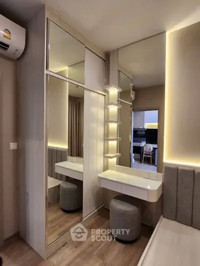 Modern bedroom with mirrored wardrobe and stylish vanity area