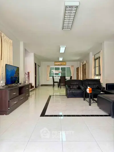 Spacious living room with modern furniture and open layout, perfect for family gatherings.