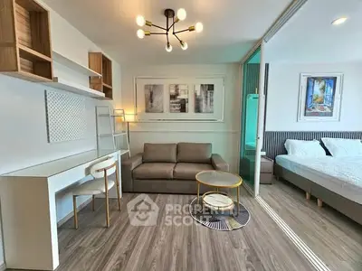 Modern studio apartment with stylish living area and cozy bedroom, featuring sleek furniture and contemporary decor.