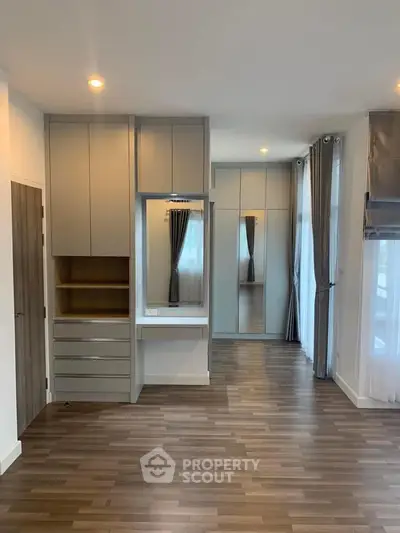 Modern bedroom with built-in wardrobe and elegant wood flooring