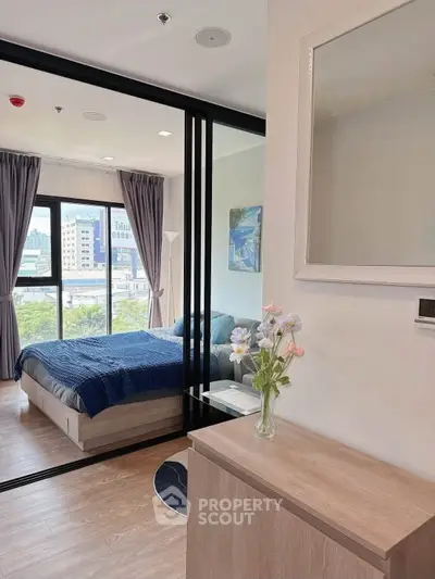 Modern bedroom with large windows and stylish decor in a high-rise apartment.