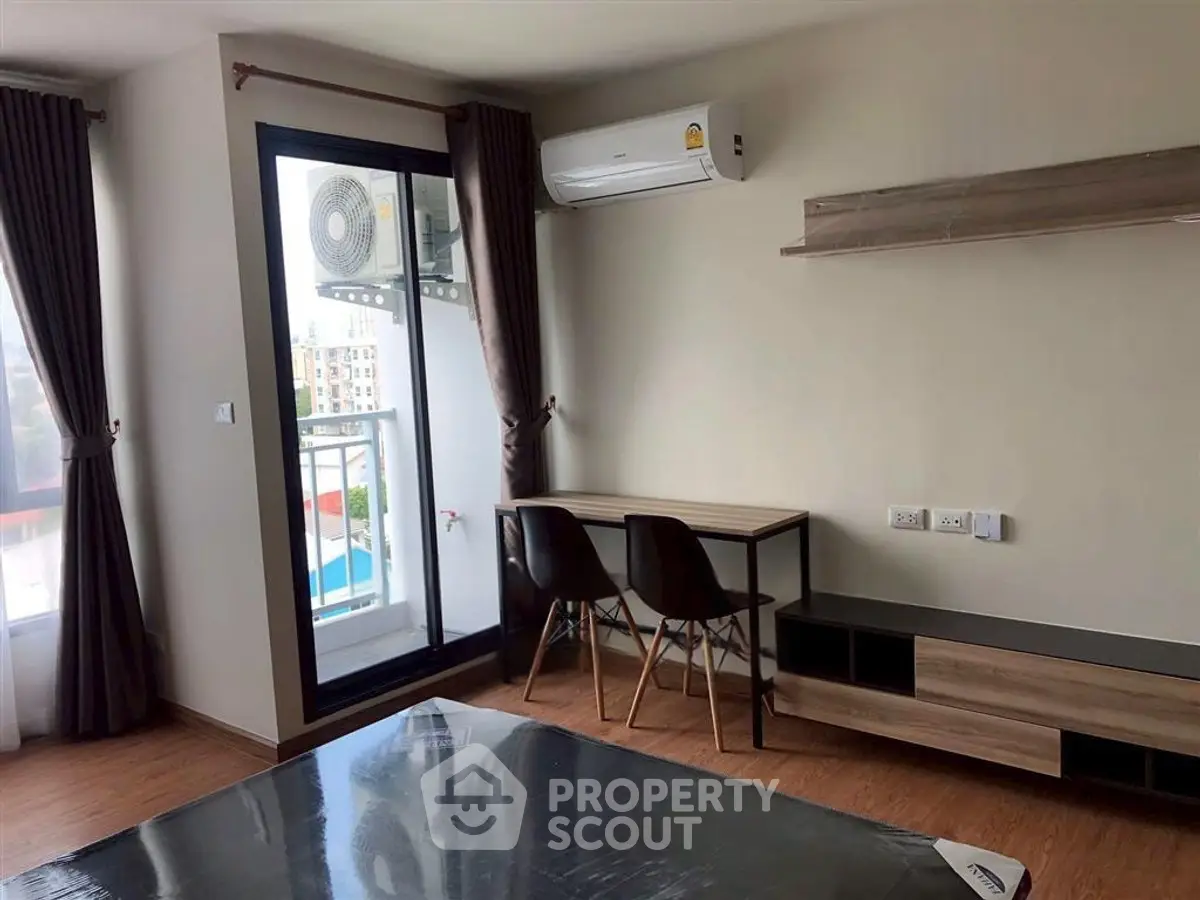 Modern apartment interior with balcony, air conditioning, and stylish furniture.
