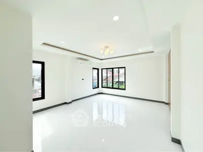 Spacious and bright living room with modern design and large windows.