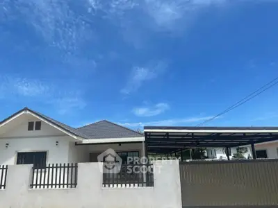 Charming single-story home with modern design and spacious carport under a clear blue sky.