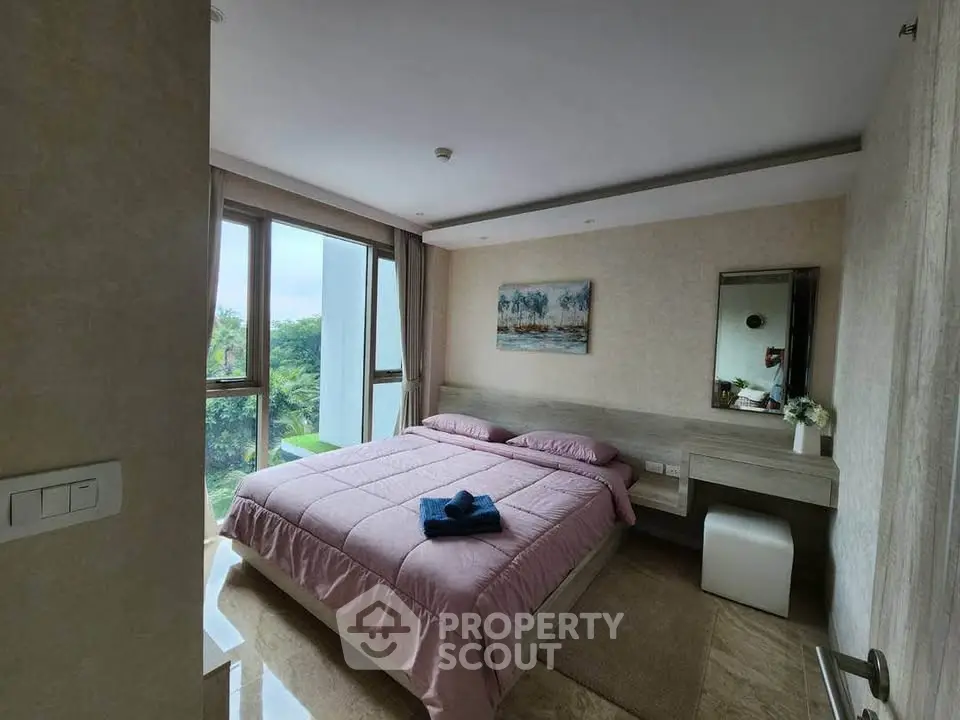 Spacious bedroom with large windows and scenic view, featuring modern decor and cozy ambiance.