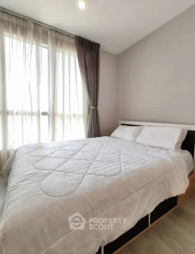 Bright and cozy bedroom with large window and modern decor