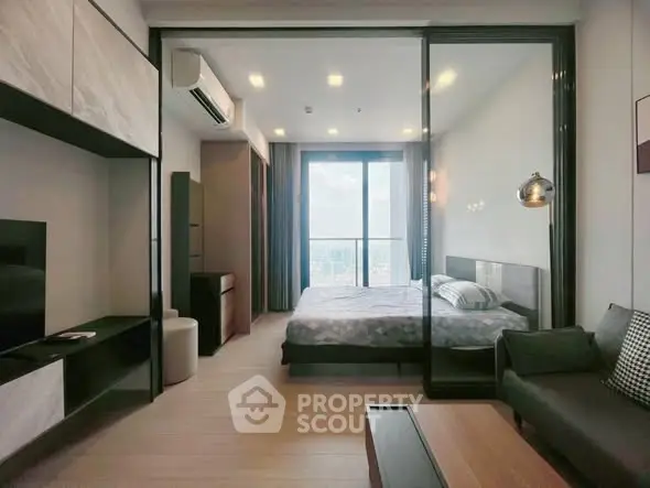 Modern bedroom with glass partition and city view in high-rise apartment