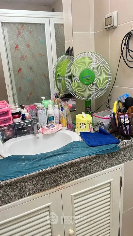 Compact bathroom with granite countertop and essential toiletries