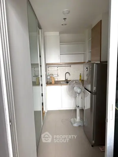 Compact kitchen with modern appliances and sleek design