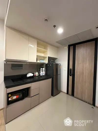 Modern kitchen with sleek cabinets and appliances in a stylish apartment