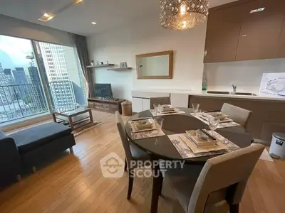 Modern living room with dining area and city view balcony, elegant decor and natural light.