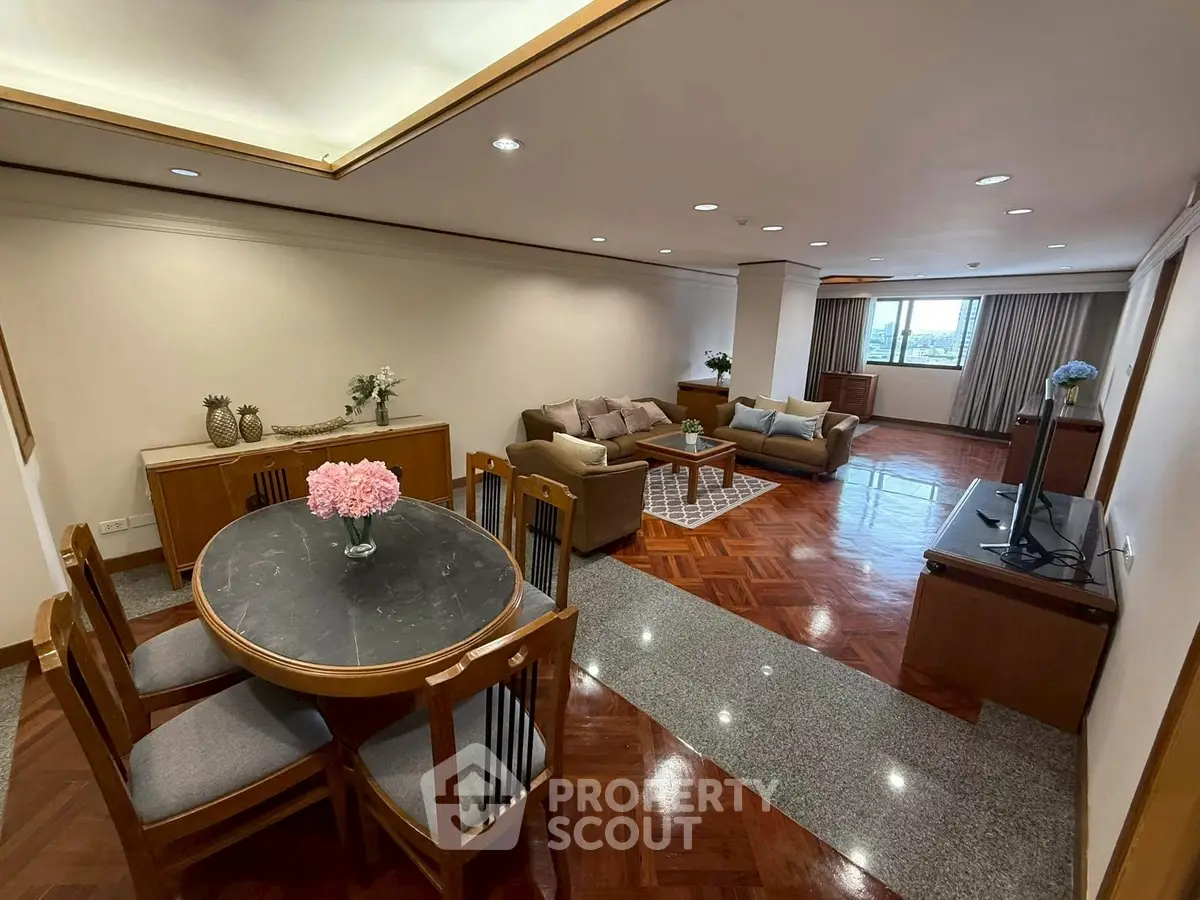 Spacious living room with elegant dining area and city view, perfect for modern living.