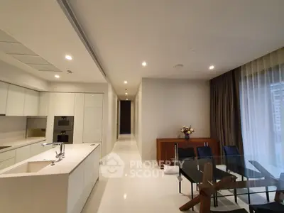 Luxurious open-plan kitchen and dining area with modern design and elegant furnishings.