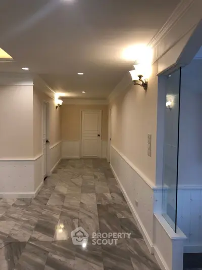 Elegant hallway with marble flooring and modern lighting in luxury property
