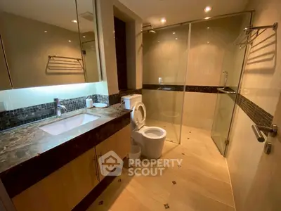 Luxurious modern bathroom with marble countertop and glass shower enclosure