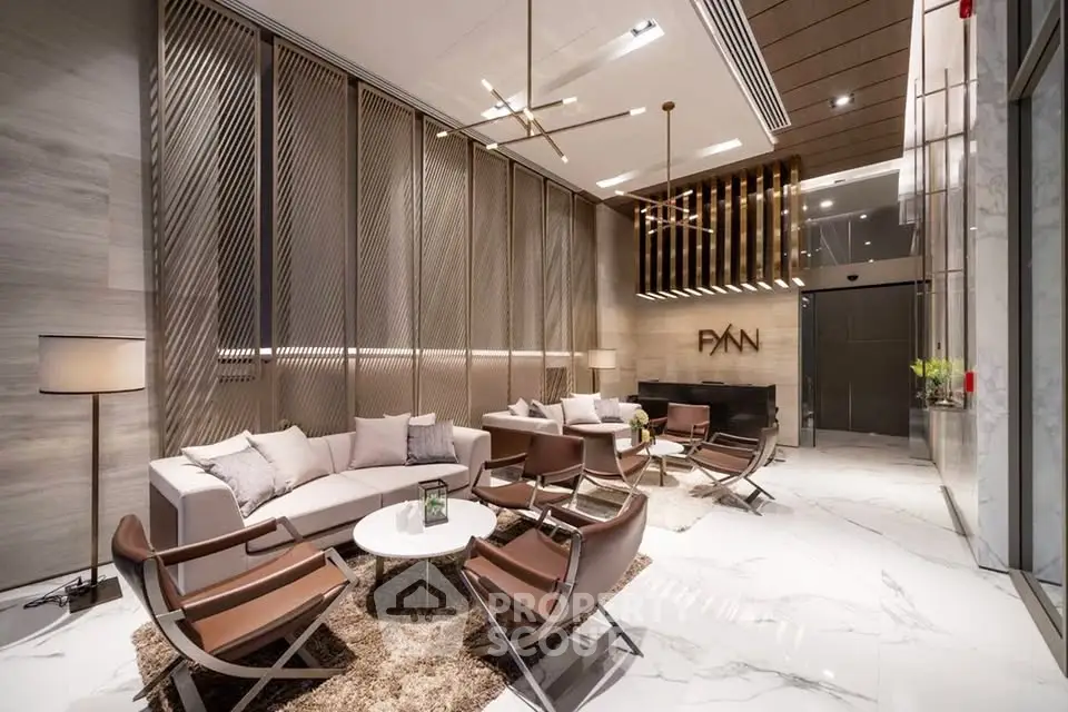Luxurious modern lobby with elegant seating and stylish decor in a high-end building.