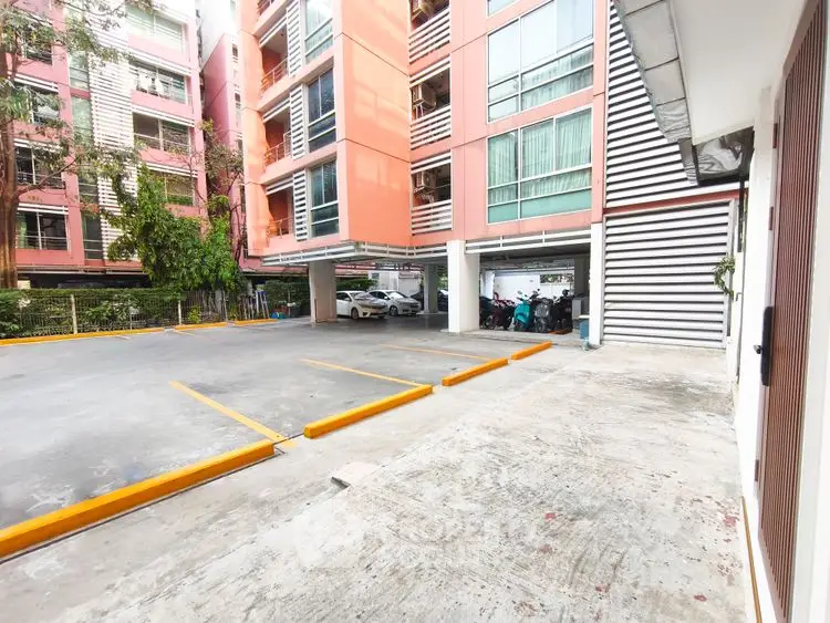 Spacious parking area in modern residential building with ample parking spaces and secure environment.