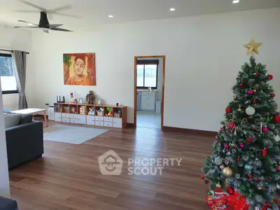 Spacious living room with festive decor and modern furnishings