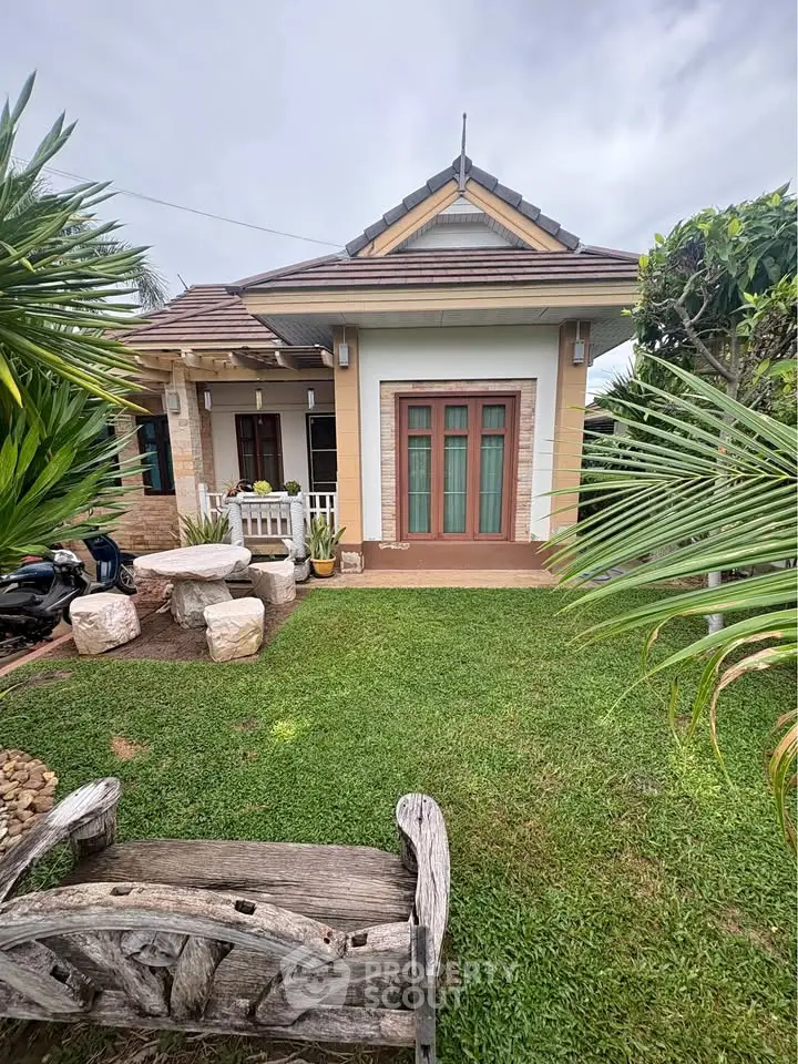 Charming single-story home with lush garden and inviting entrance, perfect for serene living.