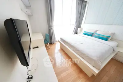 Modern minimalist bedroom with natural light and sleek furnishings