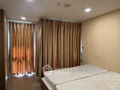 Cozy bedroom with twin beds and warm lighting, perfect for relaxation.