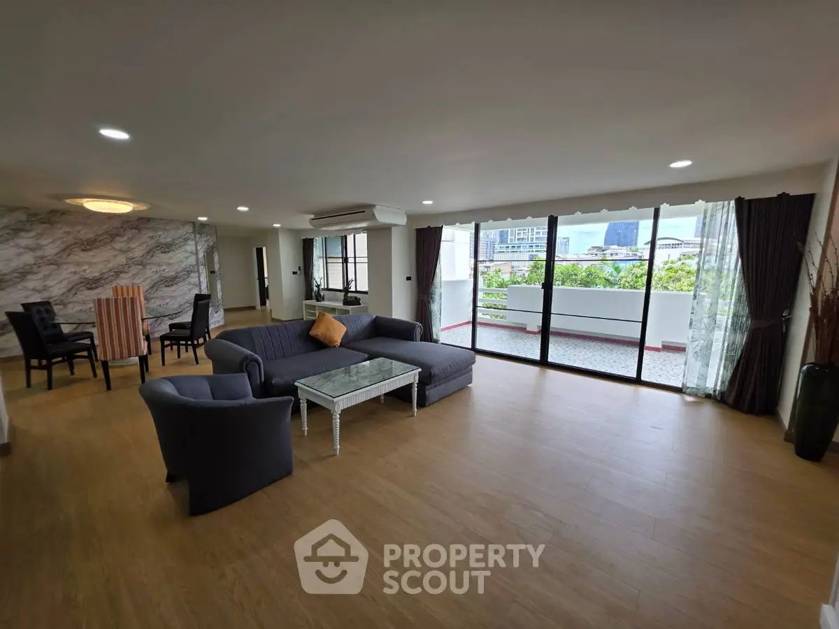 Spacious living room with modern decor and large balcony view