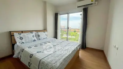 Bright bedroom with balcony and city view, featuring modern decor and air conditioning.