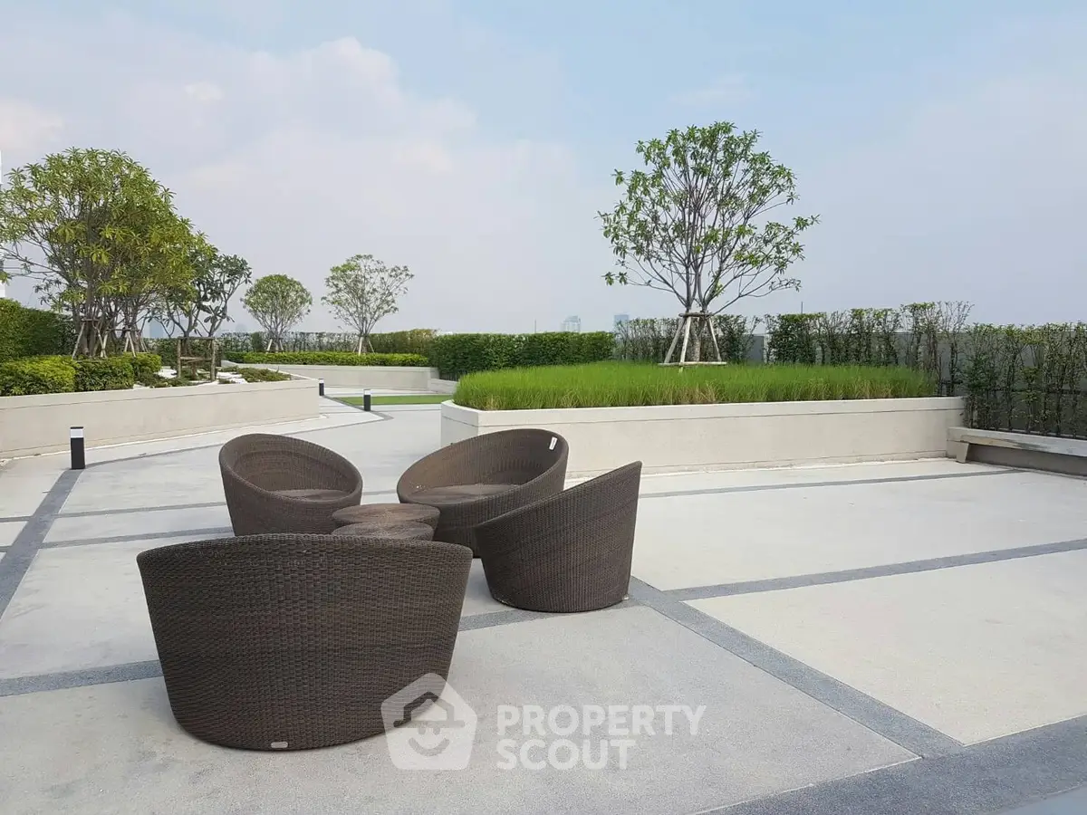 Luxurious rooftop terrace with modern outdoor seating and lush greenery, perfect for relaxation and entertainment.