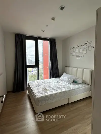 Modern bedroom with large window and stylish decor in urban apartment