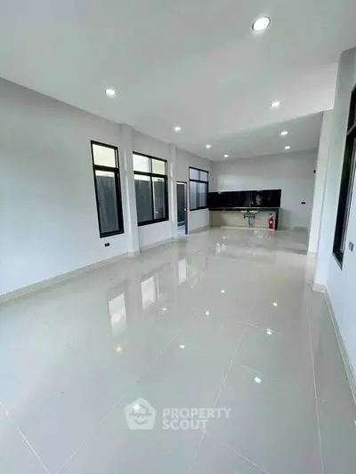 Spacious modern living room with sleek tile flooring and large windows