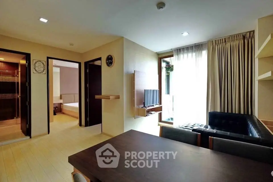 Modern living room with natural light, sleek furniture, and open layout in a stylish apartment.