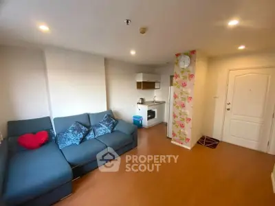 Cozy living room with modern sofa and compact kitchen area