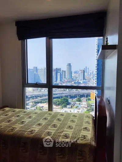 Stunning city view from a cozy bedroom with large windows and elegant decor.