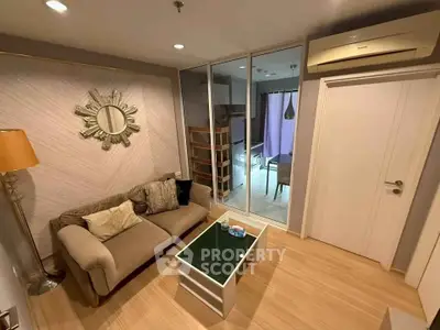 Stylish living room with modern decor and mirrored closet doors.