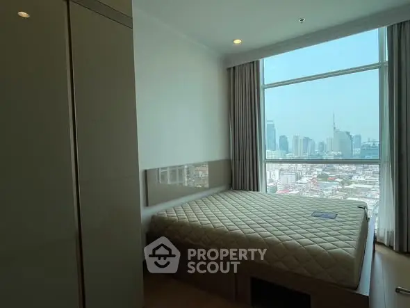 Modern bedroom with city view in high-rise apartment