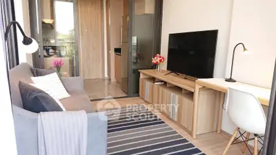 Modern living room with stylish decor, cozy sofa, and sleek TV setup in a bright apartment.