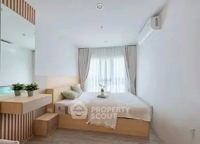 Modern bedroom with minimalist design, featuring a large window and stylish decor.