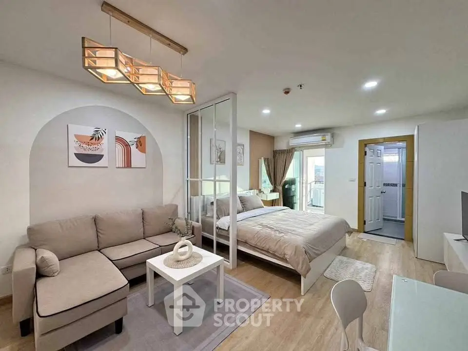 Modern studio apartment with open layout, cozy living area, and stylish decor.
