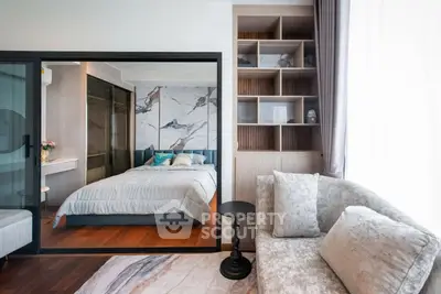 Luxurious bedroom with elegant decor and cozy living area, featuring modern design and ample natural light.