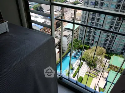 Stunning high-rise balcony view overlooking pool and cityscape