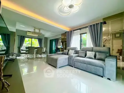 Luxurious modern living room with elegant decor and ample natural light.