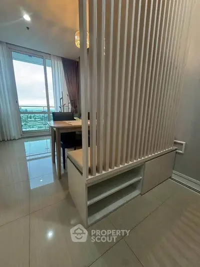 Modern living room with stylish partition and large windows offering a stunning view.