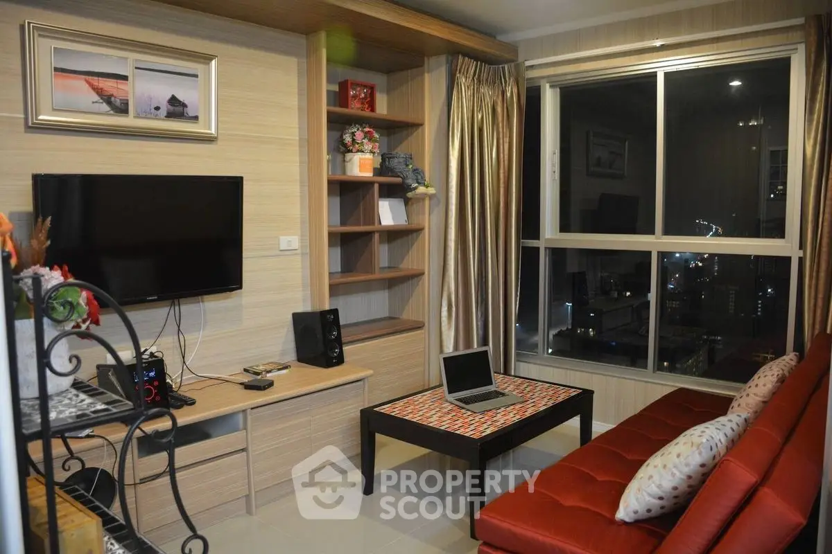 Modern living room with city view, featuring sleek furniture and stylish decor.