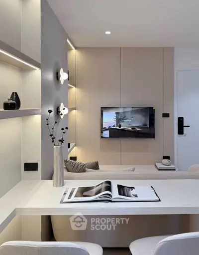 Modern living room with sleek design, built-in shelves, and wall-mounted TV for stylish urban living.