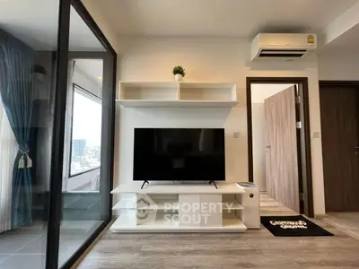 Modern living room with sleek TV stand and balcony view, featuring air conditioning and stylish decor.