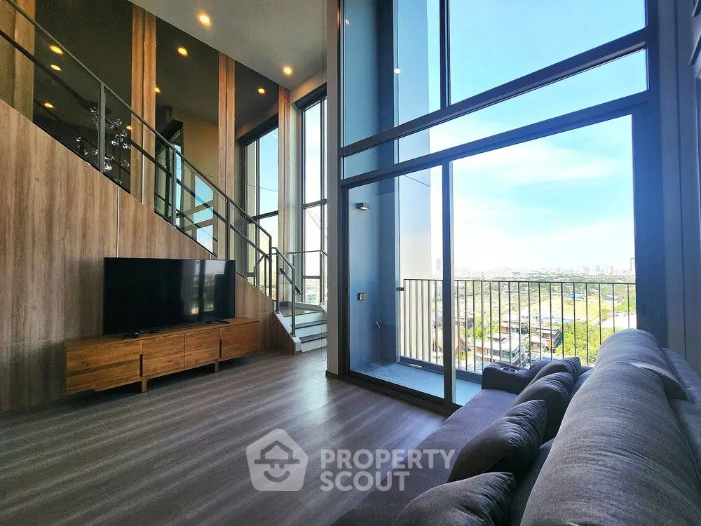 Stunning modern living room with floor-to-ceiling windows and balcony view