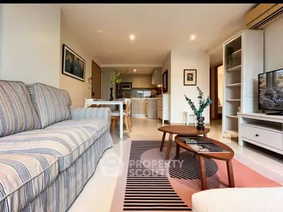 Stylish living room with modern decor and open kitchen layout, perfect for urban living.
