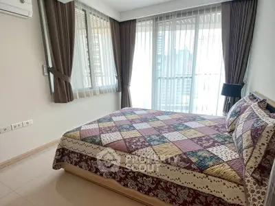 Spacious bedroom with large windows and elegant curtains in modern apartment