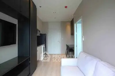 Modern living room with sleek furniture and integrated appliances